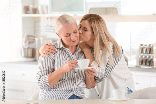 Young woman drinking tea wi...