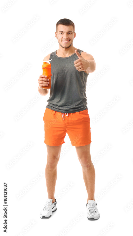 Handsome young man with protein shake showing thumb up gesture on white background Handsome young man with protein shake showing thumb up gesture on white background