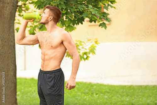 Handsome young man drinking...