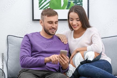 Young couple on sofa at home