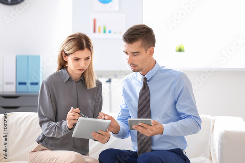 Young man and woman sitting...