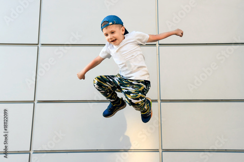 The boy jumped up against the wall photo