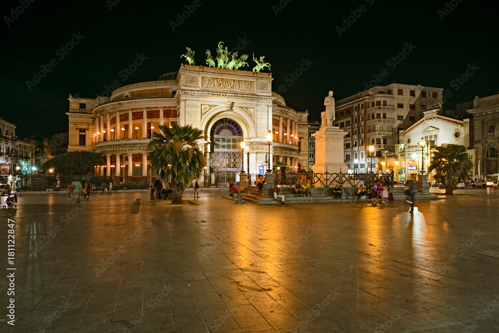 in a warm summer evening, tourists in Politeama Square in the center of Palermo, Sicily.