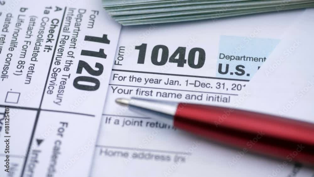 Tax Form 1040, 1120, and dollar bills, close up
Tax Form 1040, 1120, and dollar bills, close up