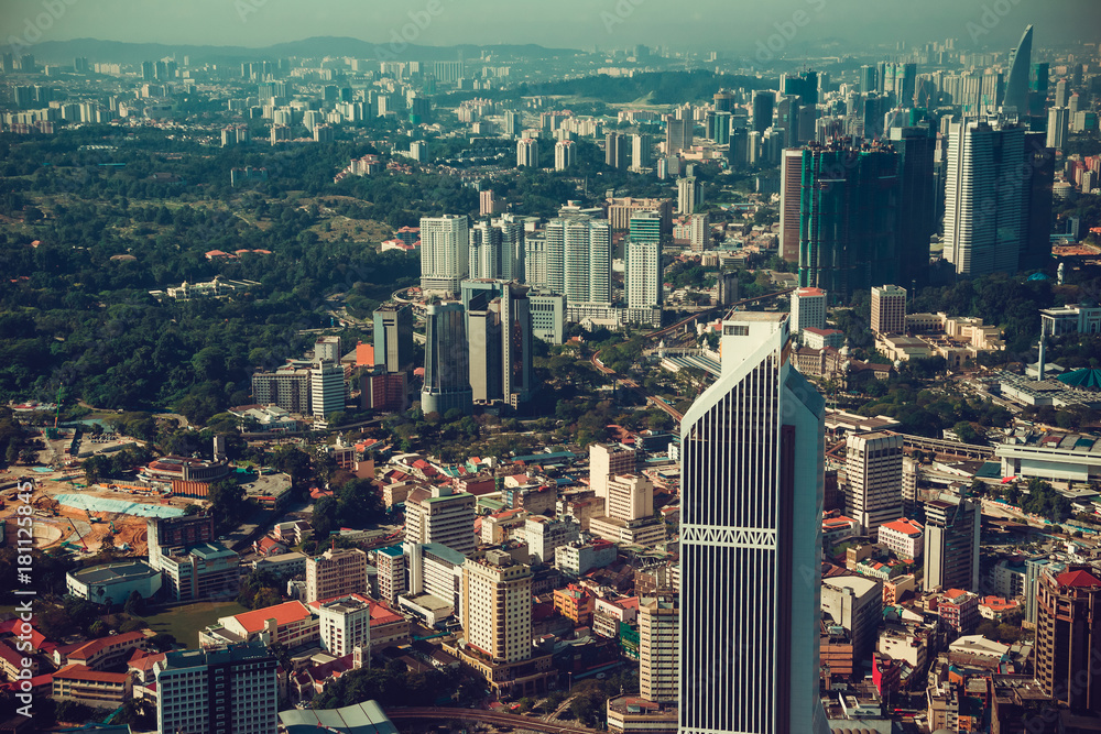 Fototapeta premium Modern architecture, business office building, cityscape background. Travel to Malaysia. Urban skyscrapers. Modern city. Financial district. Aerial view downtown. City tour. Kuala Lumpur public park.