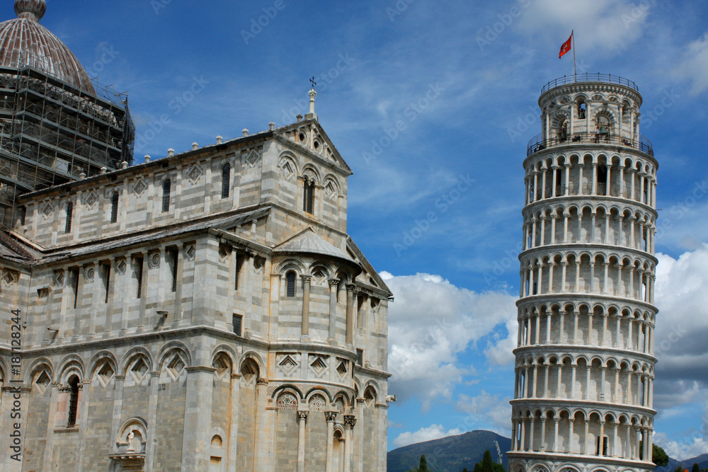 Leaning tower on right with Pisa cathedral on left in Pisa, Italy
