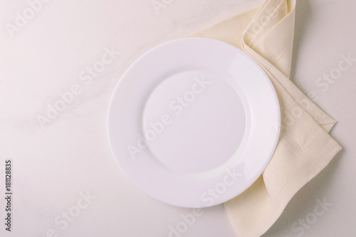 Food background. White empty plate, napkin. Top view, copyspace.