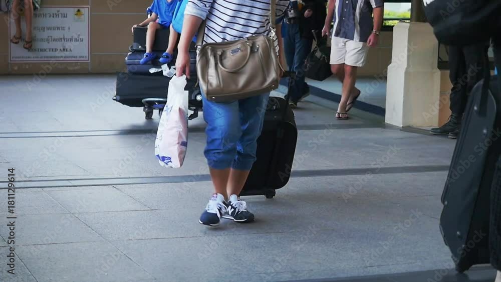 Travelers pulling suitcase from airport terminal on Koh Samui in slow motion. 1920x1080, hd Travelers pulling suitcase from airport terminal on Koh Samui in slow motion. 1920x1080, hd