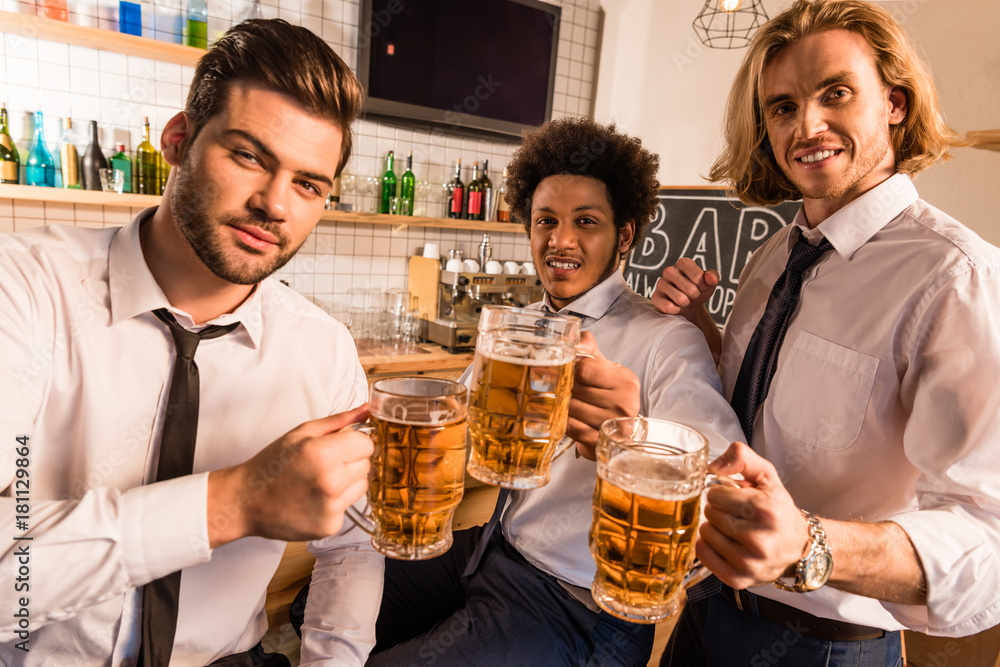 businessmen drinking beer in bar