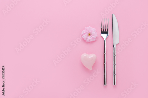 event decoration with cherry flower, hearth and cutlery set on pink