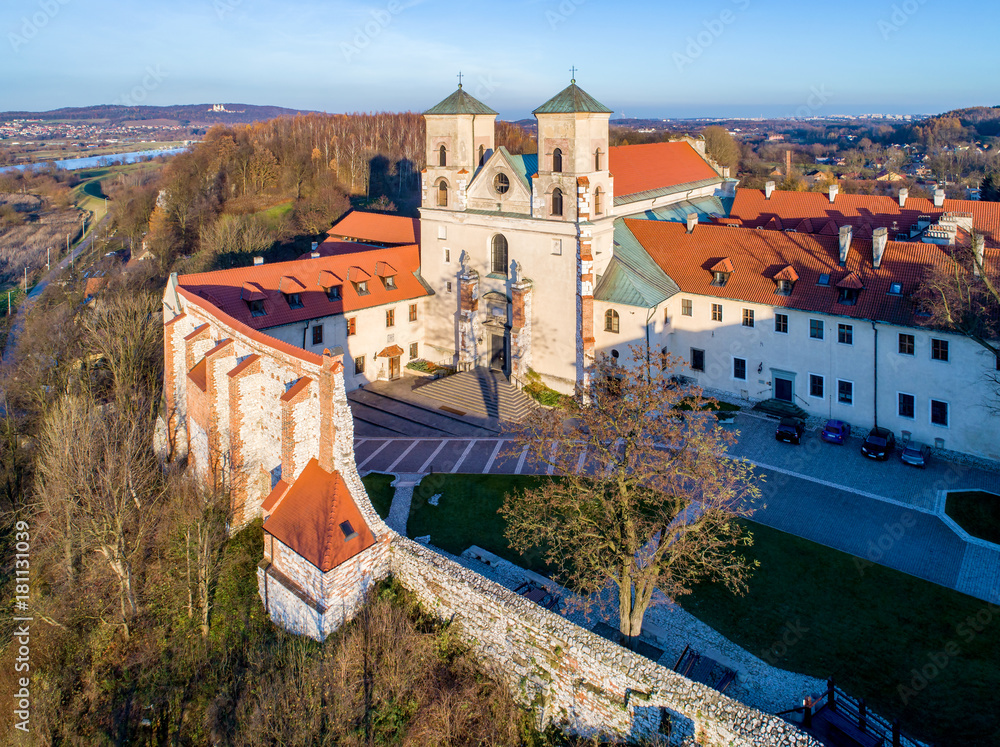 Tyniec near Krakow, Poland. Benedictine abbey and Saint Peter and Paul church on the rocky hill at Vistula River. Aerial view. Late fall in sunset light.