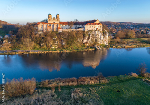Tyniec near Krakow  Poland. Benedictine abbey on the rocky cliff and its reflection in Vistula River. Aerial view in fall in sunset light