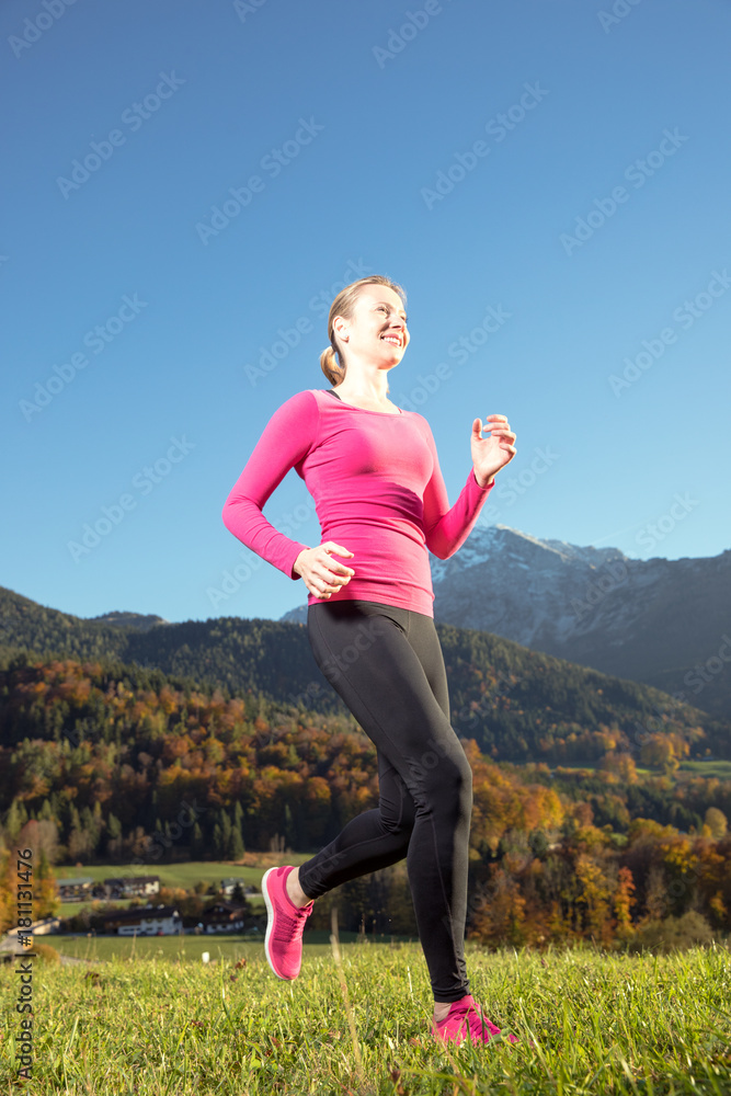 Young, sexy woman runs through a colorful autumn forest in the mountains - she is doing her running workout outdoor at a beautiful sundown and a amazing landscape Young, sexy woman runs through a colorful autumn forest in the mountains - she is doing her running workout outdoor at a beautiful sundown and a amazing landscape