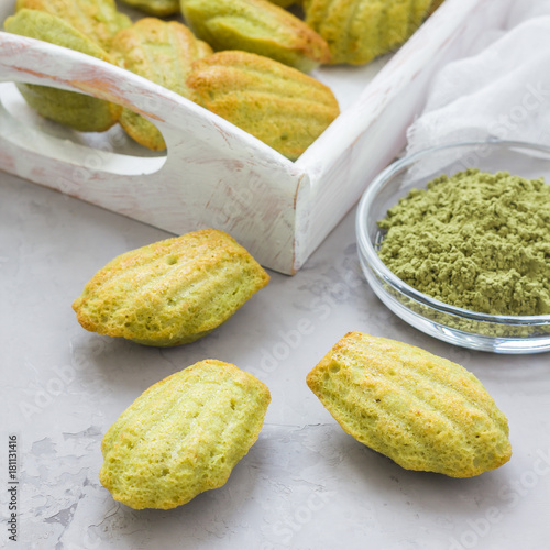 Konstfotografi Matcha green tea madeleines on table and in wooden tray, square