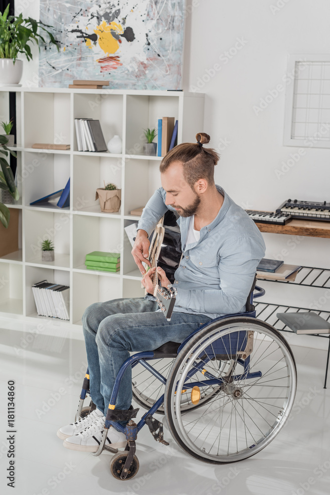 man on wheelchair playing guitar man on wheelchair playing guitar