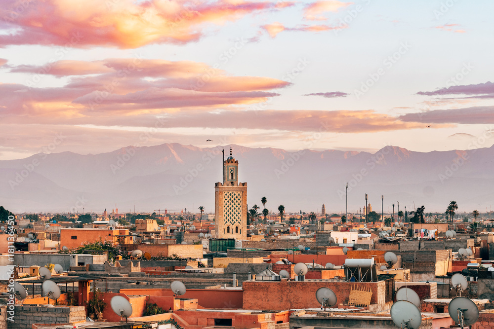panoramic views of marrakech medina with atlas mountain range at background, morocco