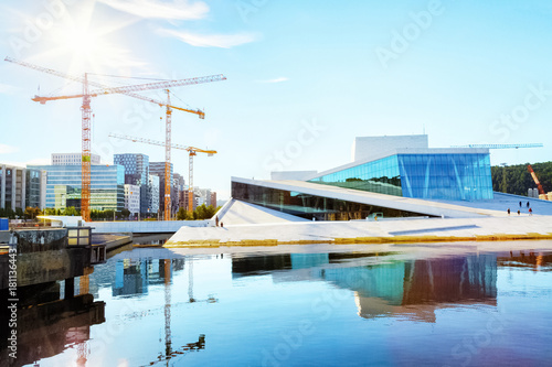Photography Opera theater modern building in Oslo, Norway, construction site with cranes in background