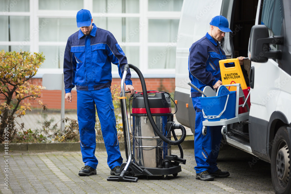 Two Male Janitor Unloading Cleaning Equipment From Vehicle Stock Photo ...