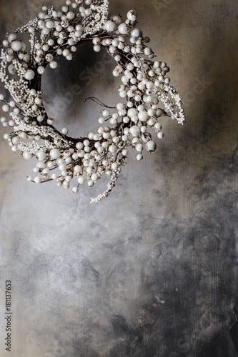 christmas wreath of branches with berries on a gray background with divorces up