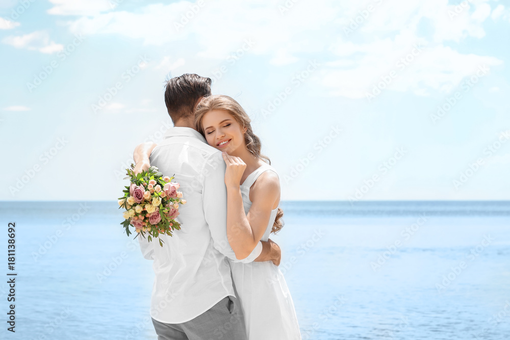 Happy newlywed couple hugging on seashore Happy newlywed couple hugging on seashore