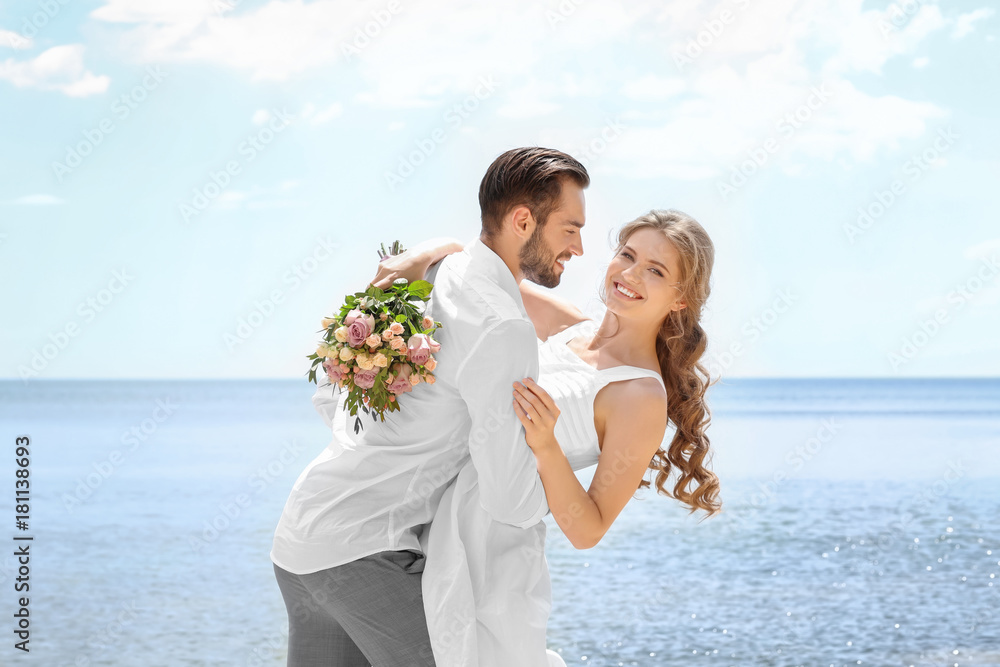Happy newlywed couple on seashore Happy newlywed couple on seashore