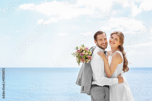 Happy newlywed couple huggi...