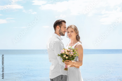 Newlywed couple standing on...