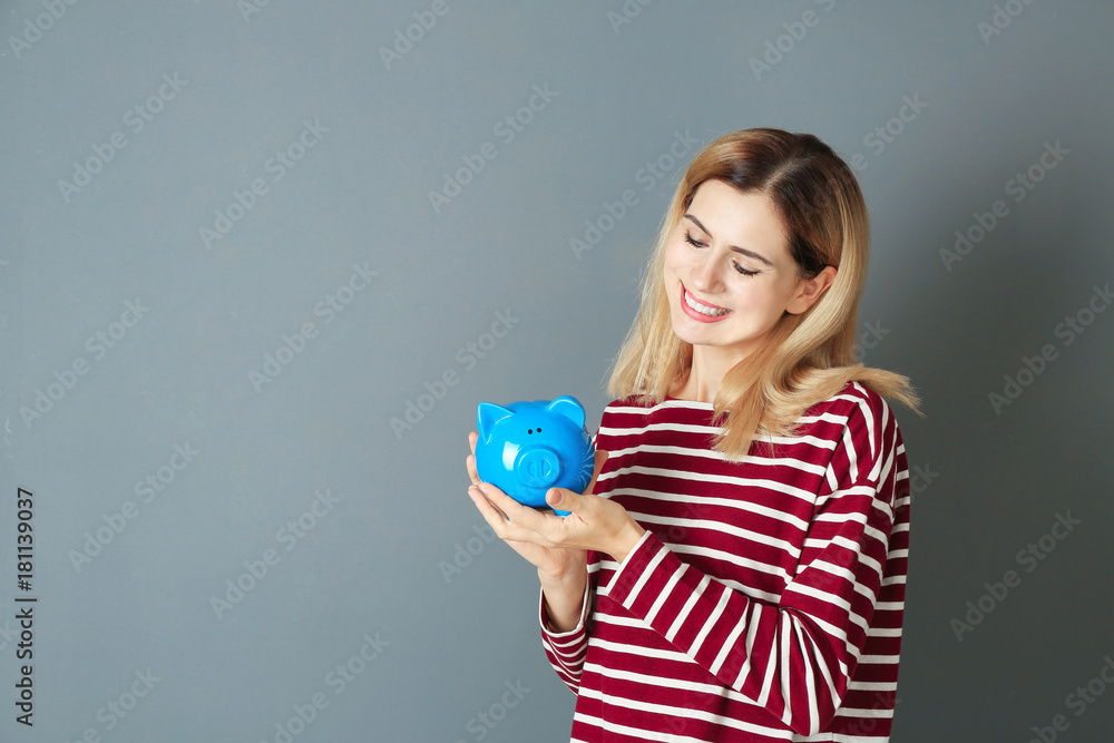 Beautiful young woman with piggy bank on color background Beautiful young woman with piggy bank on color background