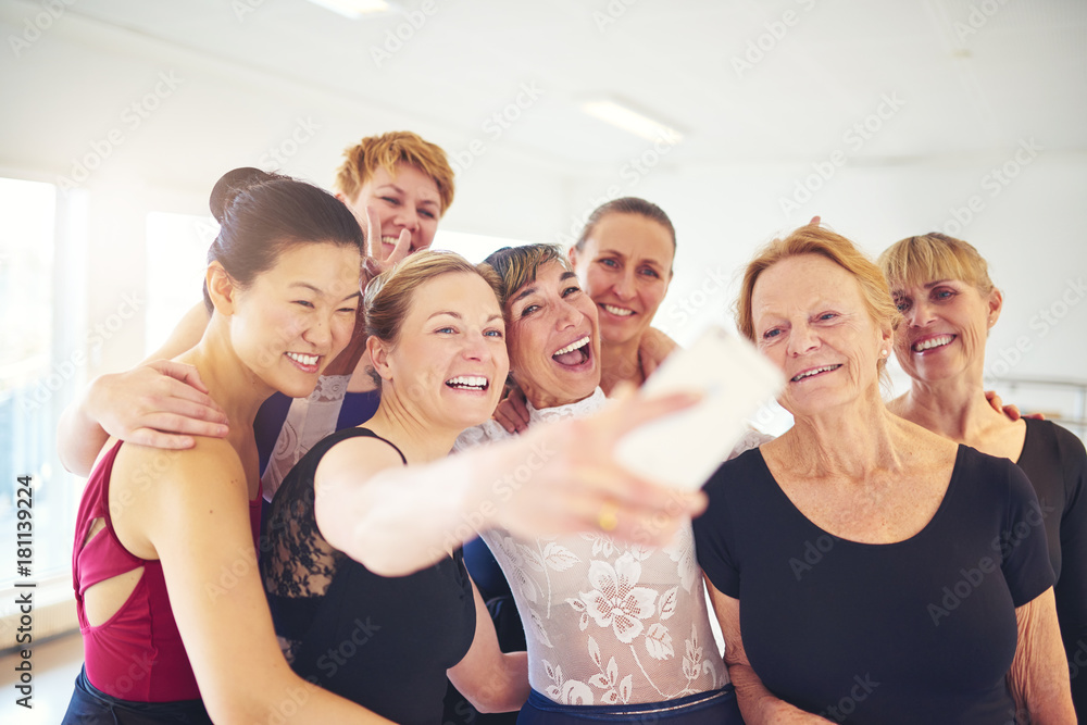 Group of smiling women taking selfies in a dance studio Group of smiling women taking selfies in a dance studio