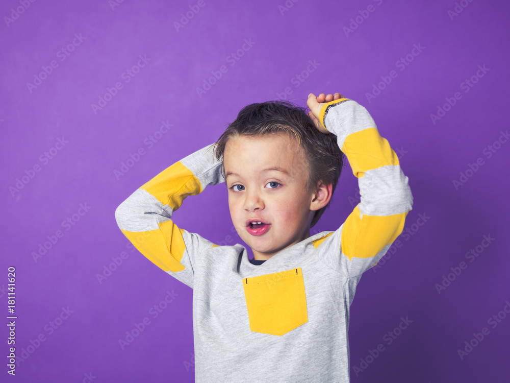 5 year old boy portrait in front of violet background 5 year old boy portrait in front of violet background