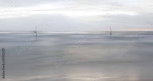 View of Indian ocean in blur and sticks of fishermen
