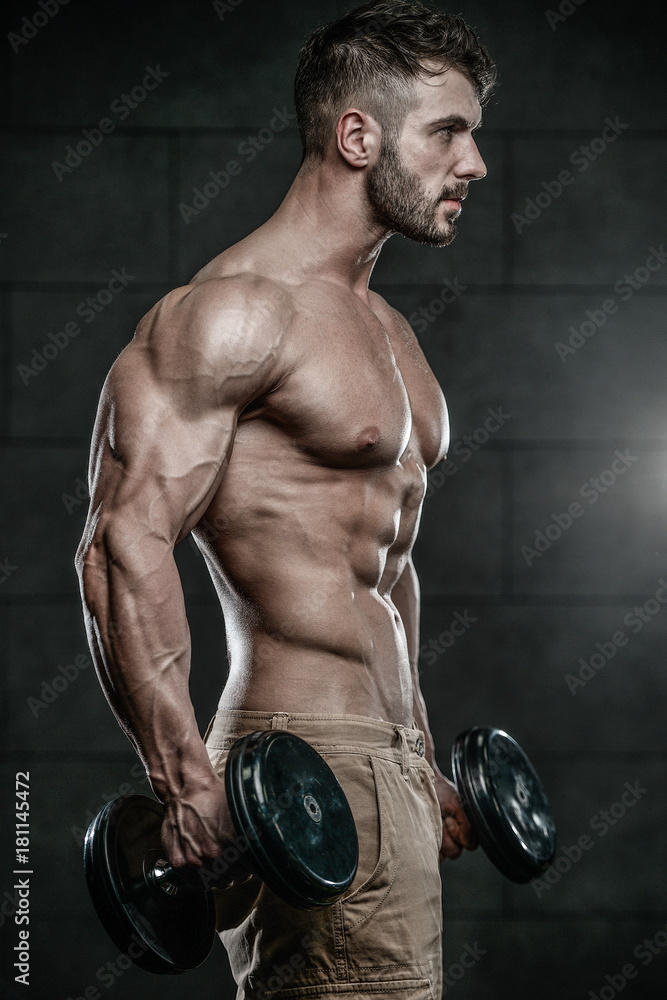 Handsome model young man training abs in gym Handsome model young man training abs in gym