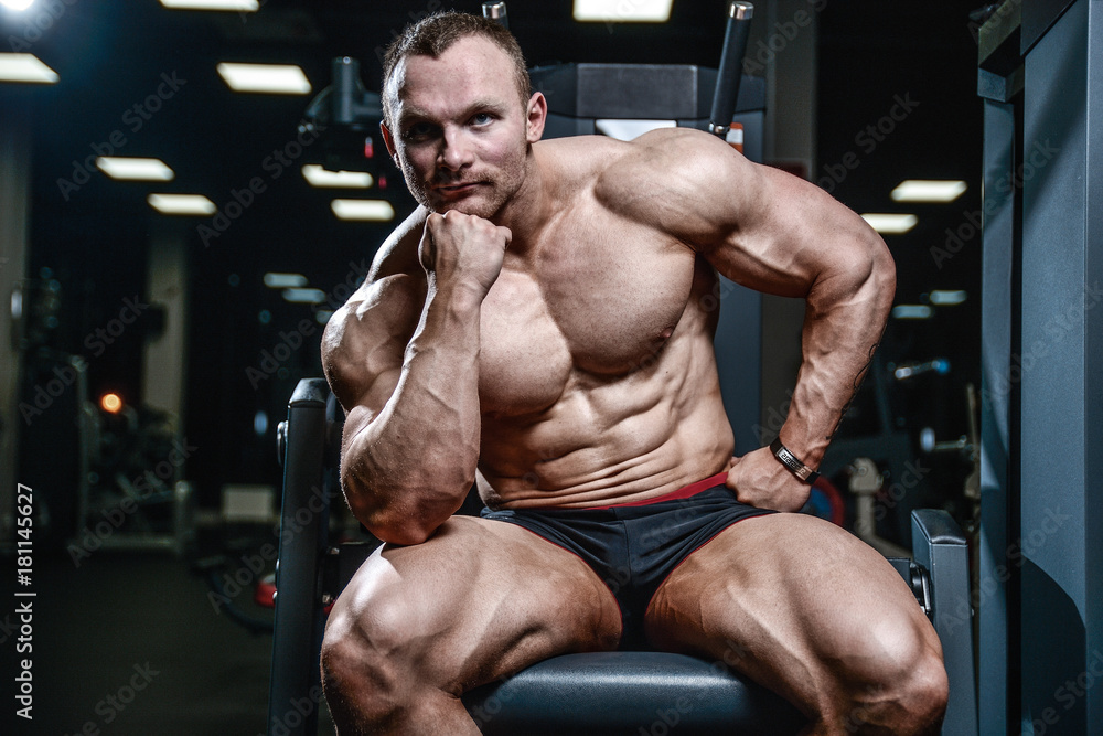 Handsome model young man posing in gym Handsome model young man posing in gym