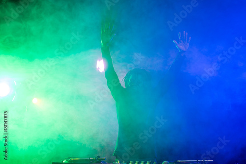 DJ in nightclub with back light