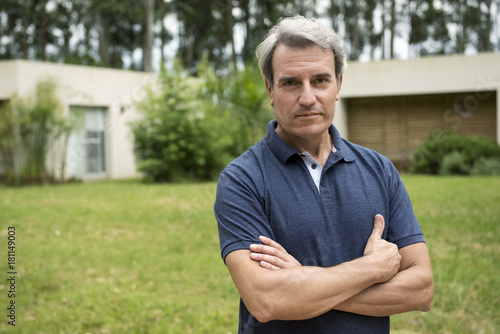 Mature man with arms folded across chest, portrait photo