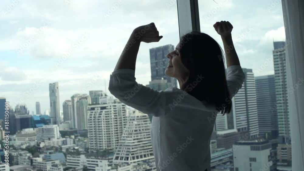 Happy, successful businesswoman admire view from window in office
Happy, successful businesswoman admire view from window in office