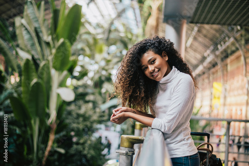 Charming delightful mixed race woman with curly hair. photo