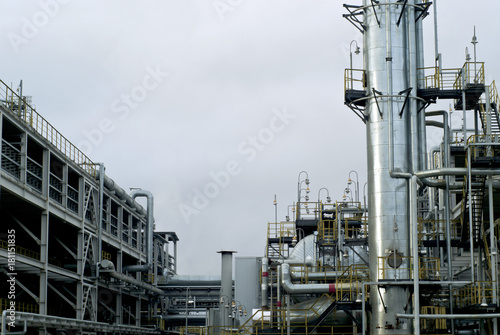 Section of the distillery plant of a modern oil refinery with a fractionating column, tanks and pipelines