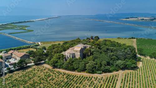 Aerial top view of old church on island from above, canal du Rhone a Sete, Camargue, France 