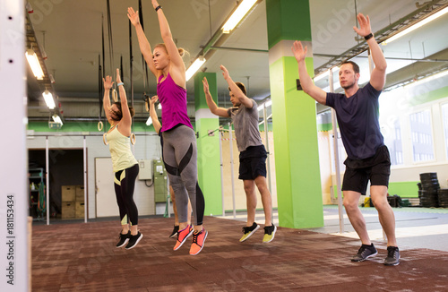group of people exercising and jumping in gym © Syda Productions