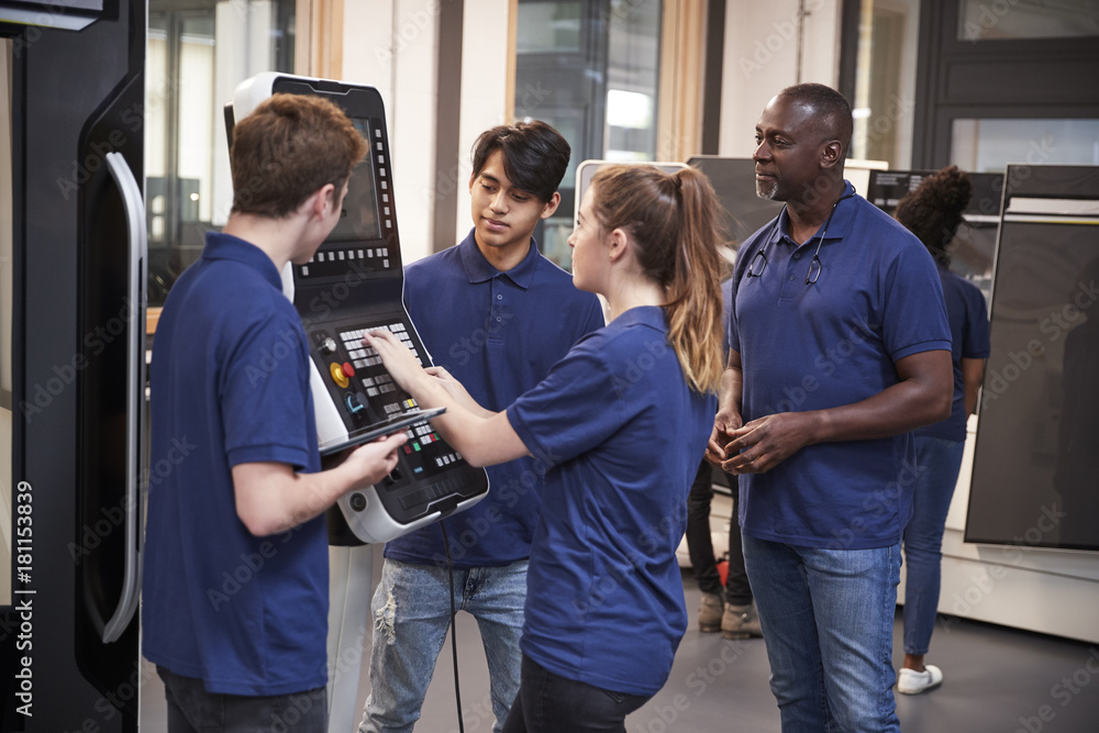 Fototapeta premium Engineer Showing Apprentices How To Use CNC Tool Making Machine