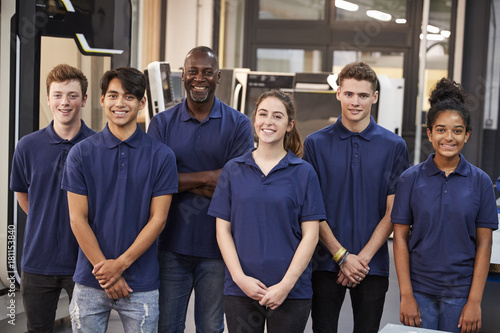 Portrait Of Engineer And Apprentices In Factory photo
