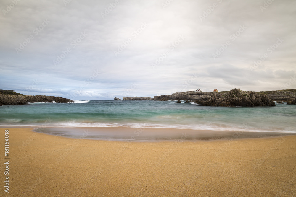 beautiful beach with waves breaking on the shore and without people
