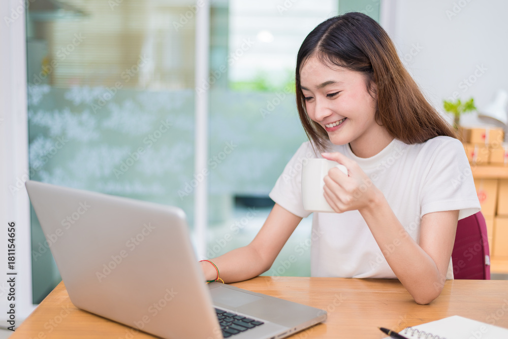 Asian woman enjoy herself while using laptops and internet in office. Business and marketing and part time concept. On line shopping and business success theme. Happy mood doing working job. Asian woman enjoy herself while using laptops and internet in office. Business and marketing and part time concept. On line shopping and business success theme. Happy mood doing working job.