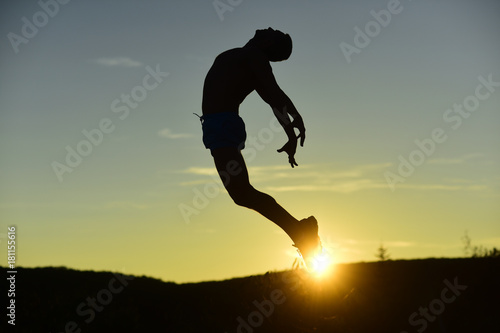 Sport and training concept. Silhouette of athlete jumping