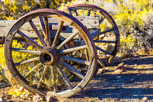 Two Wooden Wagon Wheels At Sunrise