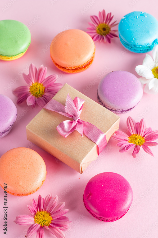 Photo of cake macarons, gift box, tea, coffee, cappuccino and flowers. Sweet romantic food macaroon concept. Morning breakfast and presents. Photo of cake macarons, gift box, tea, coffee, cappuccino and flowers. Sweet romantic food macaroon concept. Morning breakfast and presents.