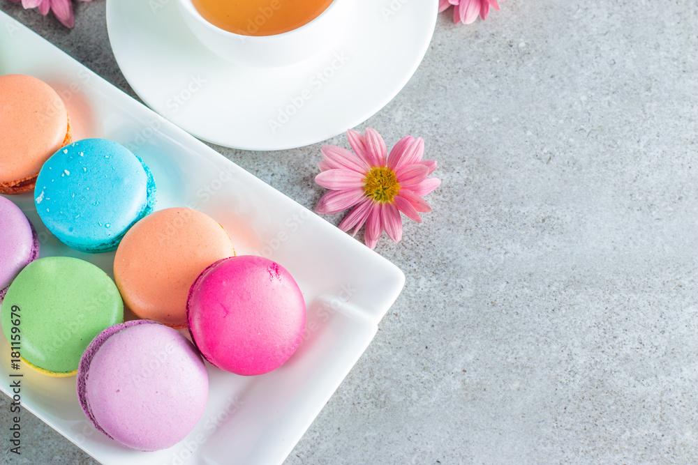 Photo of cake macarons, gift box, tea, coffee, cappuccino and flowers. Sweet romantic food macaroon concept. Morning breakfast and presents. Photo of cake macarons, gift box, tea, coffee, cappuccino and flowers. Sweet romantic food macaroon concept. Morning breakfast and presents.