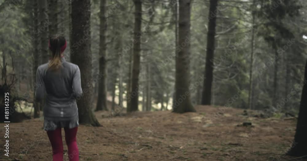 Athlete girl running through forest woods.Following behind.Real people woman runner sport training in autumn or winter in wild mountain outdoors nature, bad foggy weather.4k 60p slow motion video Athlete girl running through forest woods.Following behind.Real people woman runner sport training in autumn or winter in wild mountain outdoors nature, bad foggy weather.4k 60p slow motion video