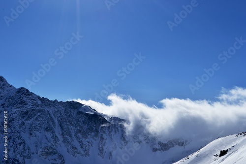 beautiful view of clouds crossing the mountain ridge. awesome mountain